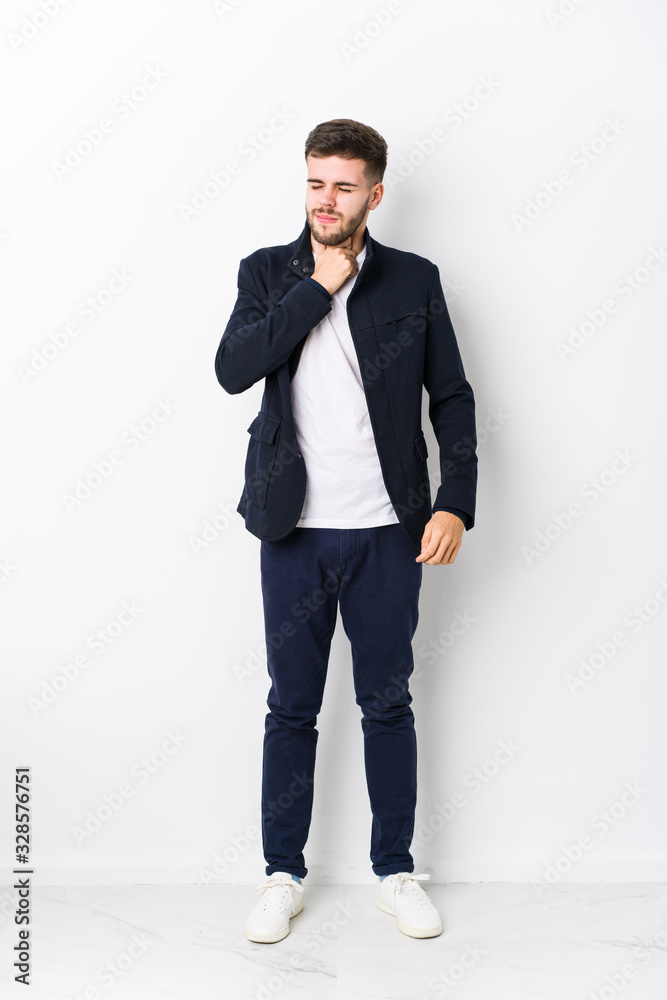 Full body young caucasian man isolated suffers pain in throat due a virus or infection. Full body young caucasian man isolated suffers pain in throat due a virus or infection.