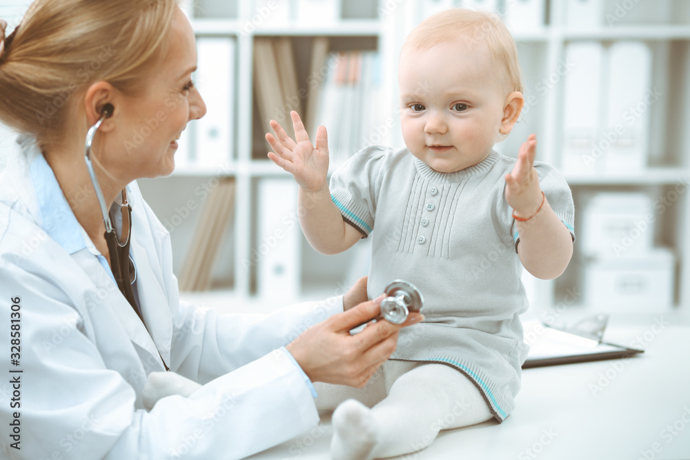Doctor and patient in hospital. Little girl is being examined by doctor with stethoscope. Medicine concept Doctor and patient in hospital. Little girl is being examined by doctor with stethoscope. Medicine concept
