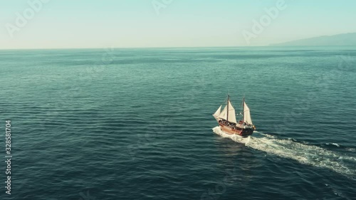A pirate sailboat in the open ocean rushes towards adventure
