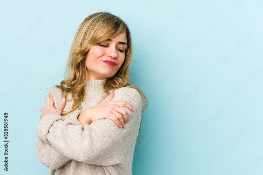 Young blonde caucasian woman hugs, smiling carefree and happy. Young blonde caucasian woman hugs, smiling carefree and happy.