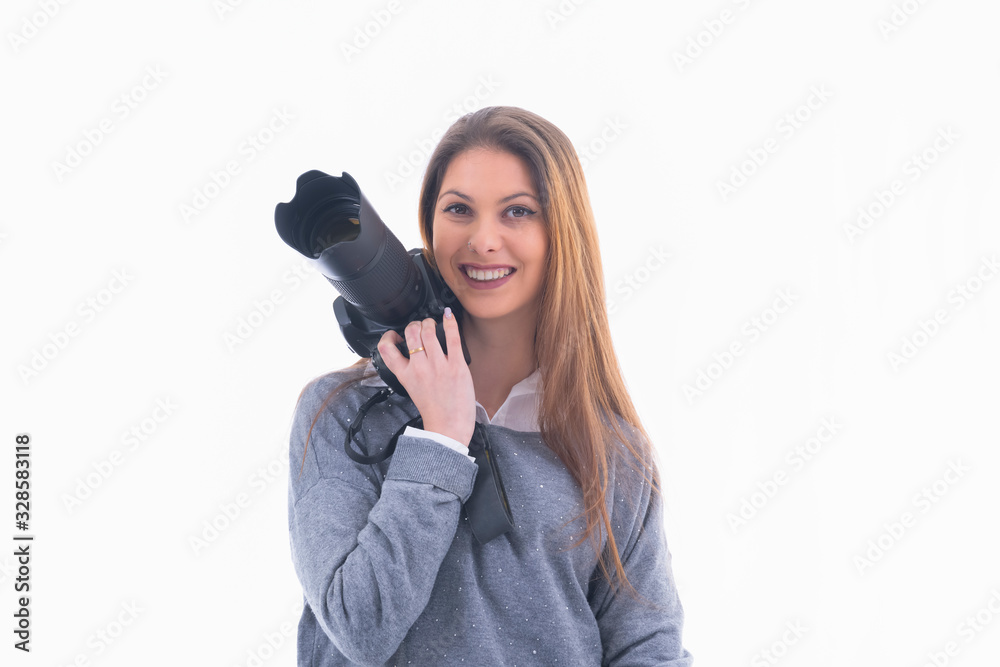 Smiling photographer holding a camera next to her face Smiling photographer holding a camera next to her face