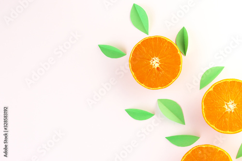 orange slices and green leaves on a white background. exotic background