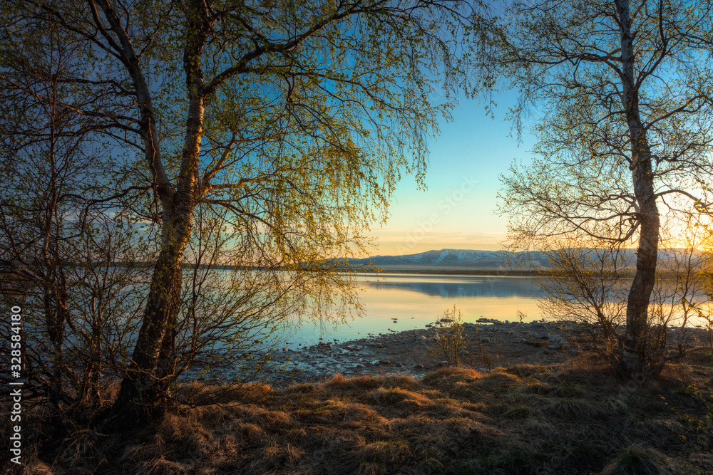 Morning sunrise on Lake Imandra. Against the backdrop of the Khibiny Mountains, Murmansk Region, Kola Peninsula. Morning sunrise on Lake Imandra. Against the backdrop of the Khibiny Mountains, Murmansk Region, Kola Peninsula.
