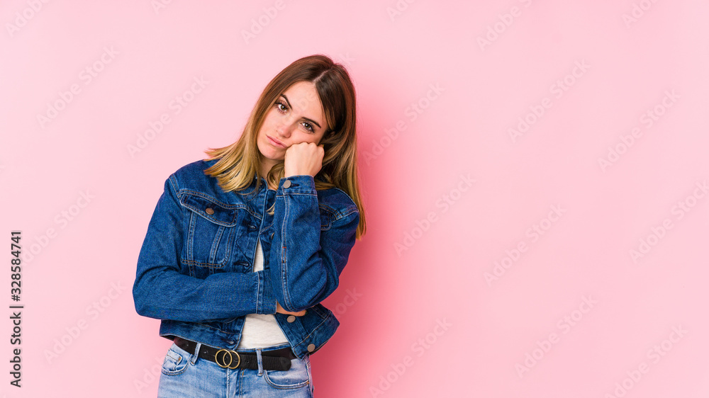 Young caucasian woman isolated on pink background who feels sad and pensive, looking at copy space. Young caucasian woman isolated on pink background who feels sad and pensive, looking at copy space.