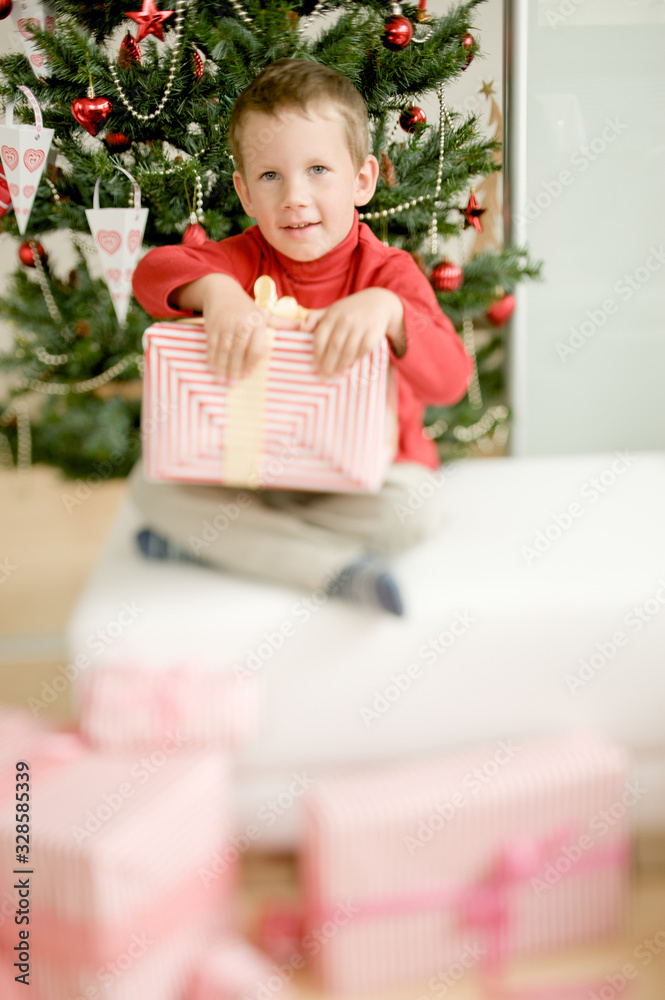 Happy child with Christmas gifts enjoying Christmas atmosphere Happy child with Christmas gifts enjoying Christmas atmosphere