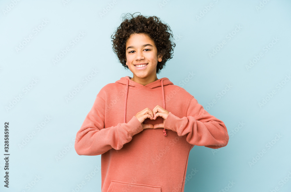 African american little boy isolated smiling and showing a heart shape with hands. - obrazy, fototapety, plakaty 