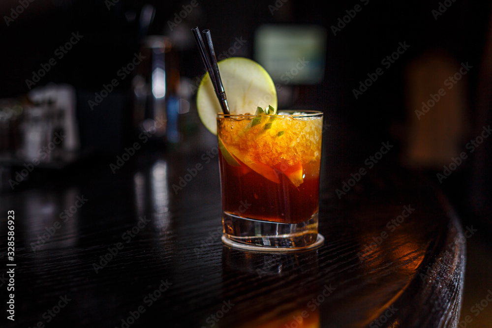 voorbeeld Internationale De daadwerkelijke A cocktail with whiskey or cognac or Cola in a highball glass is on the  counter of a dark bar. Stock Photo | Adobe Stock