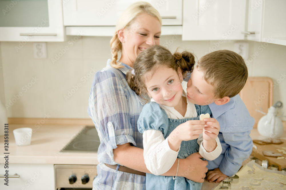 Mother with children baking cookies at home Mother with children baking cookies at home