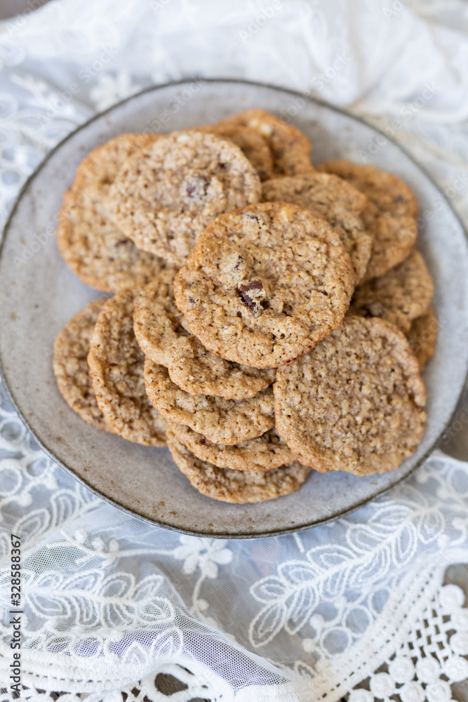 Oatmeal cookies on plate with lace and wood Oatmeal cookies on plate with lace and wood