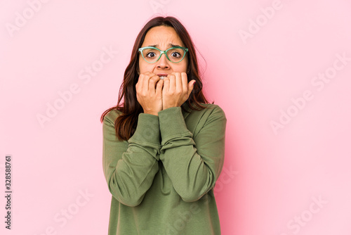 Принти на полотні Young mixed race hispanic woman isolated biting fingernails, nervous and very anxious