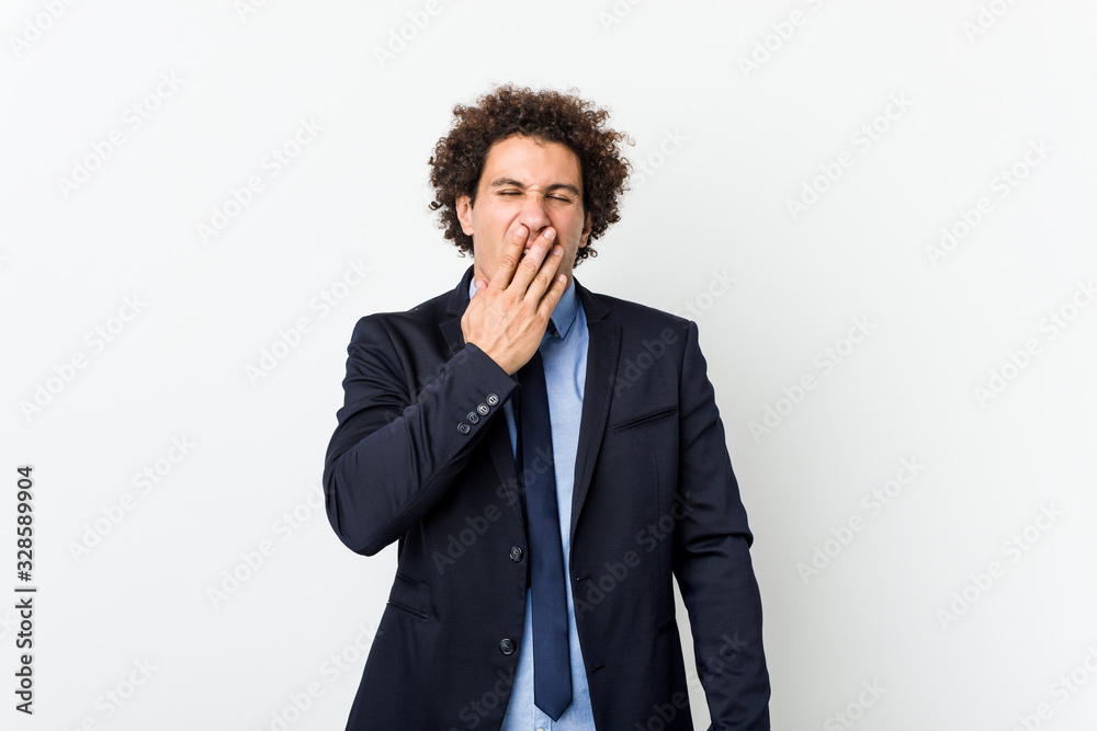 Young business curly man against white background yawning showing a tired gesture covering mouth with hand. Young business curly man against white background yawning showing a tired gesture covering mouth with hand.