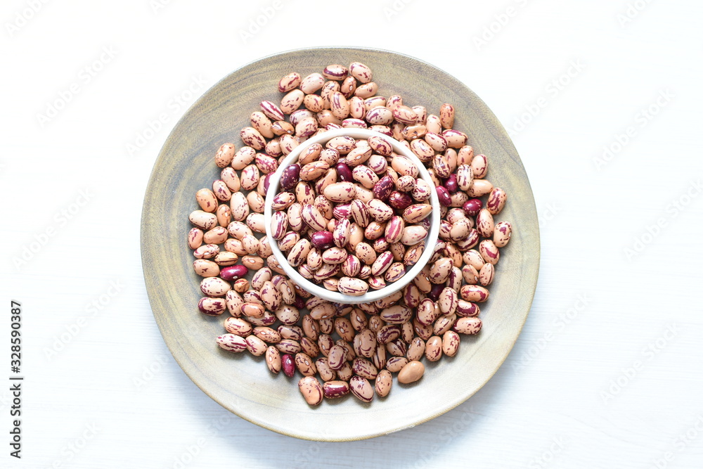 Raw bean grains (Phaseolus vulgaris) displayed in bowl Raw bean grains (Phaseolus vulgaris) displayed in bowl