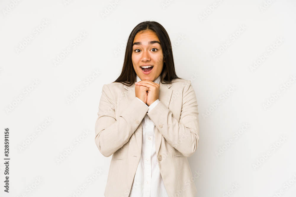 Young woman isolated on a white background praying for luck, amazed and opening mouth looking to front. Young woman isolated on a white background praying for luck, amazed and opening mouth looking to front.