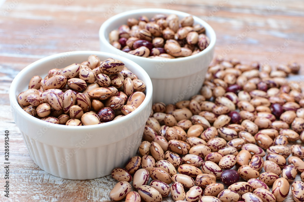 Raw bean grains (Phaseolus vulgaris) displayed in bowl Raw bean grains (Phaseolus vulgaris) displayed in bowl