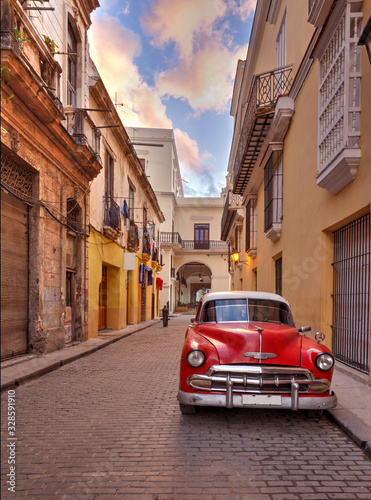 Antique American Red and White Car Parked in on a Street in Cuba © lindahughes
