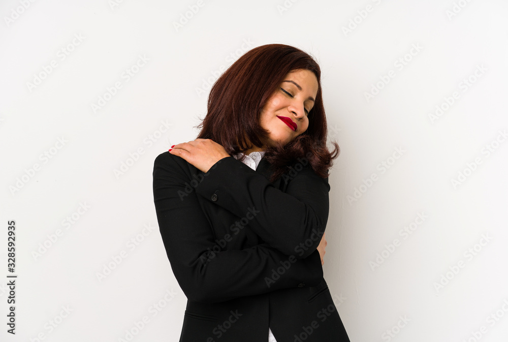 Middle age latin business woman isolated hugs, smiling carefree and happy. Middle age latin business woman isolated hugs, smiling carefree and happy.