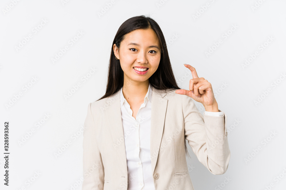Young chinese business woman isolated holding something little with forefingers, smiling and confident. Young chinese business woman isolated holding something little with forefingers, smiling and confident.