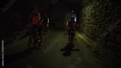 Wallpaper Mural People riding a bicycle inside a dark tunnel Torontodigital.ca