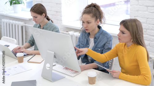 Female Designers doing Video Chat on Computer