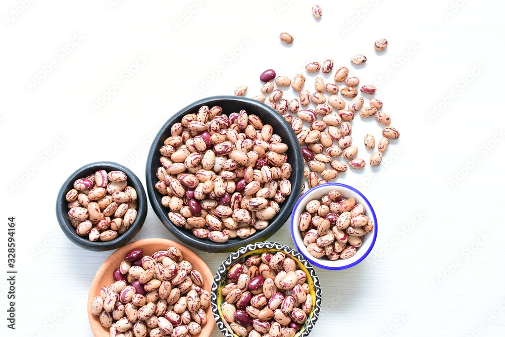 Raw bean grains (Phaseolus vulgaris) displayed in bowl Raw bean grains (Phaseolus vulgaris) displayed in bowl
