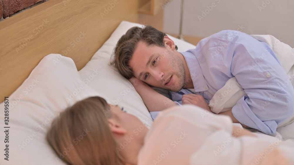 Rear View Young Couple having Discussion in Bed Rear View Young Couple having Discussion in Bed