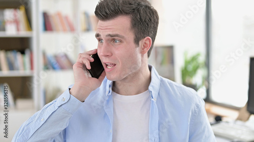 Annoyed Young Man Screaming on Smartphone