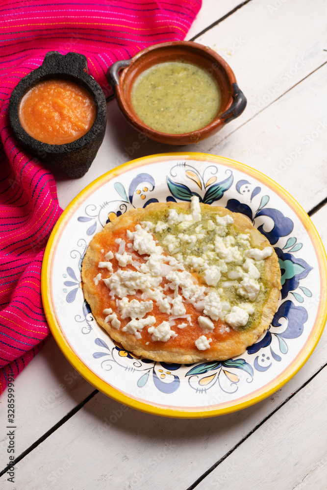Mexican memela with green and red sauce on white background Mexican memela with green and red sauce on white background