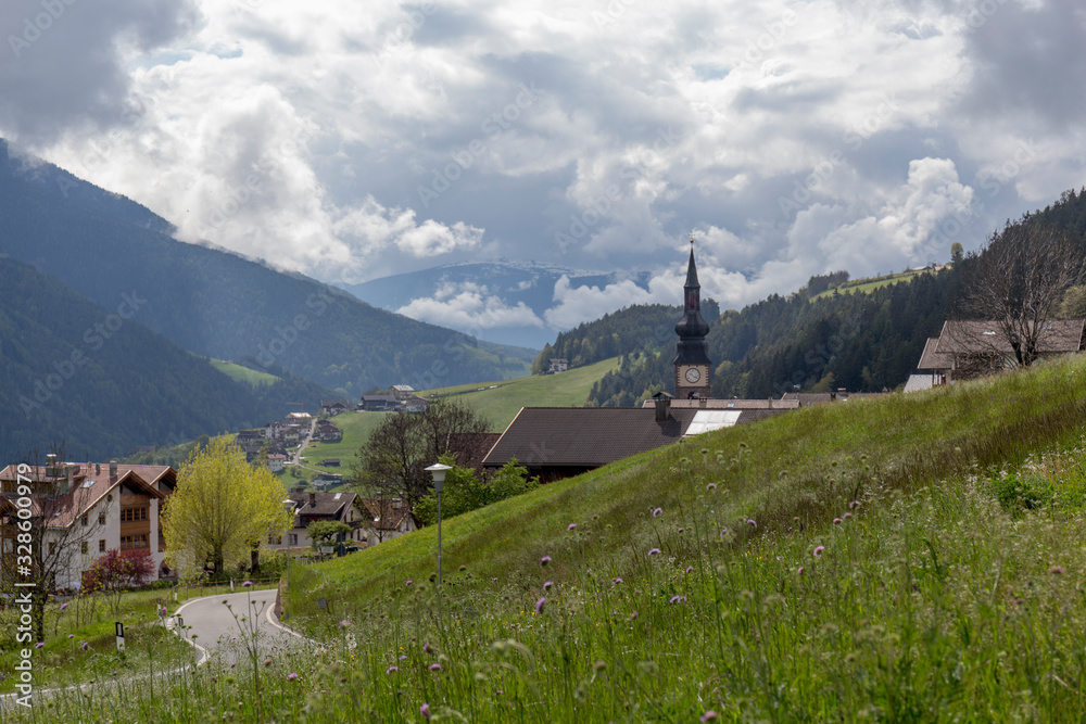 landscape of a rural village of the italian alps on a cloudy day