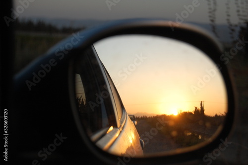 beautiful sunset reflexion through car mirroc
