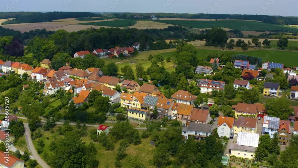 Aerial view of the village and palace Schloss Bartenstein in Germany. Pan to the right around the back end of the village. Aerial view of the village and palace Schloss Bartenstein in Germany. Pan to the right around the back end of the village.