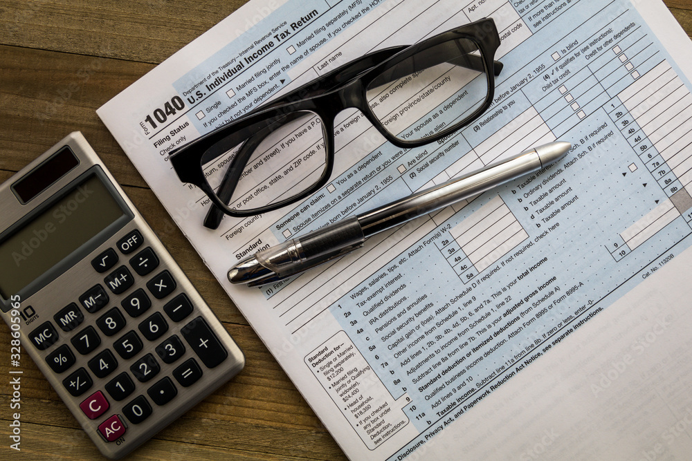 Tax Form 1040 generic no year business concept flat lay wooden board Tax Form 1040 generic no year business concept flat lay wooden board