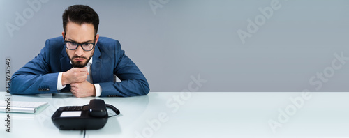 Businessman Waiting For A Call On Landline photo