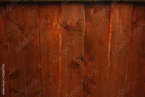 Orange wood fence plank texture background.