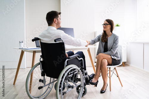 Disabled Businessman Shaking Hand With His Partner © Andrey Popov