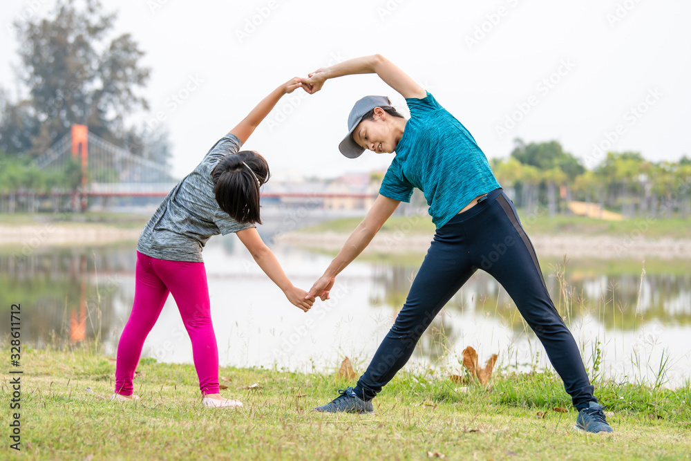 Mother and child are exercising in the park