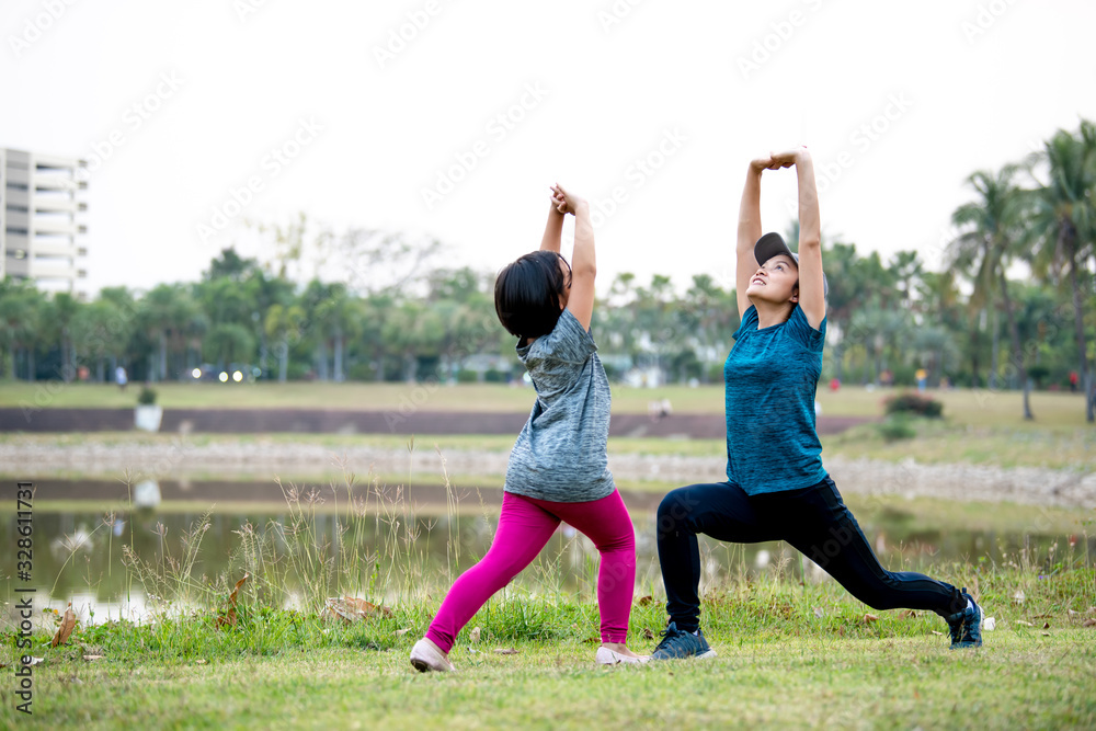 Mother and child are exercising in the park