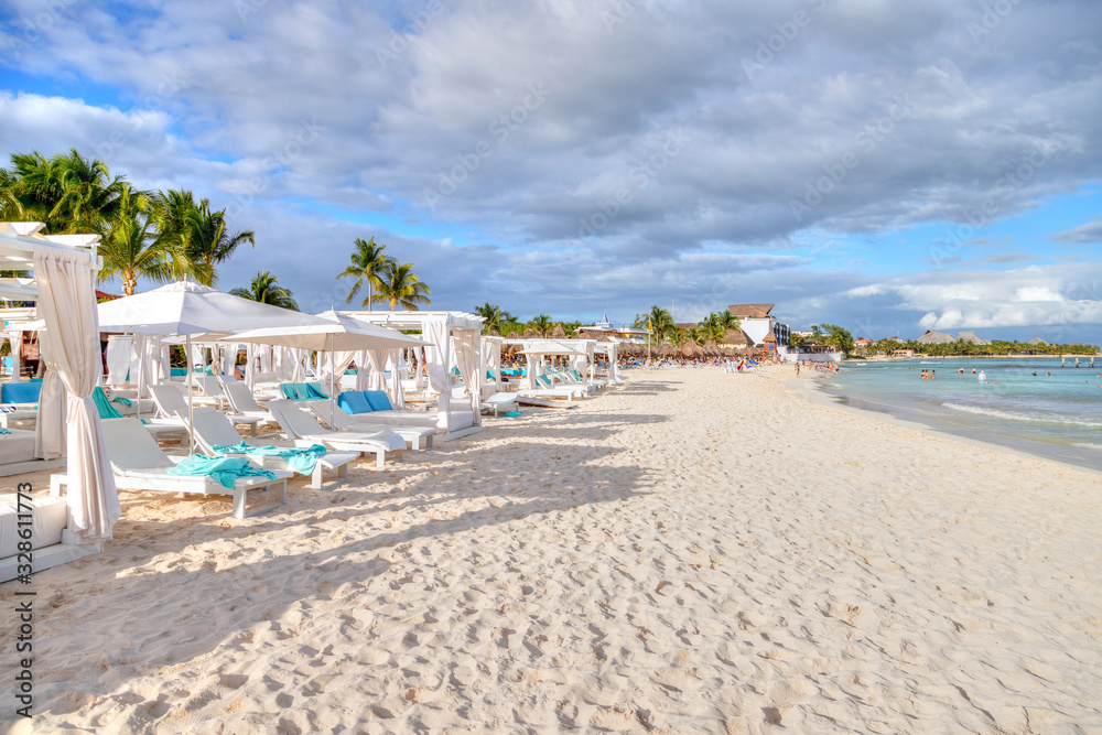 Chairs and Beds on Sunny and Sandy Tropical Beach in Caribbean