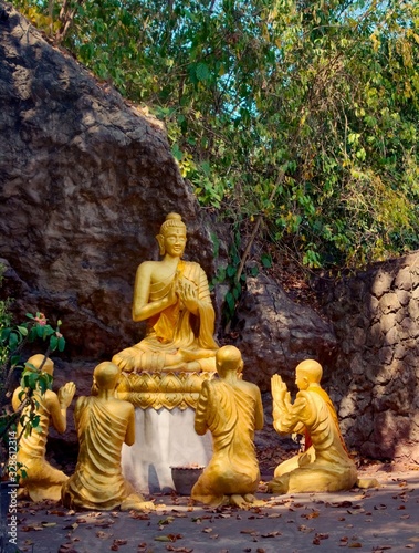 Golden statues of Buddha and disciples at Mount Phou Si  in Luang Prabang  Laos.