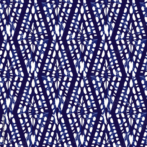 Vector blue shibori monochrome vertical diamonds zig zag seamless pattern. Suitable for textile, gift wrap and wallpaper. photo