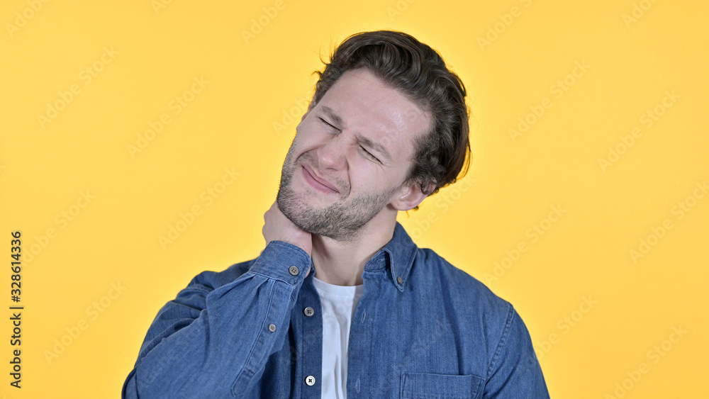 Exhausted Young Man with Neck Pain on Yellow Background Exhausted Young Man with Neck Pain on Yellow Background