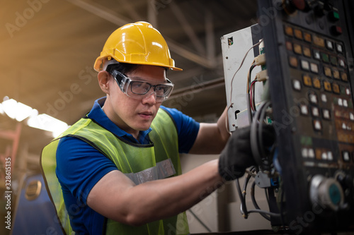 Factory technicians work on the front of the machine. © Stock_ko