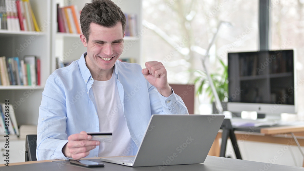 Successful Online Shopping by Young Man on Laptop