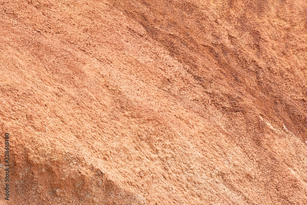 Red mountainside on hot day. Texture on wall of sandy canyon. Lack of water, drought from climate change