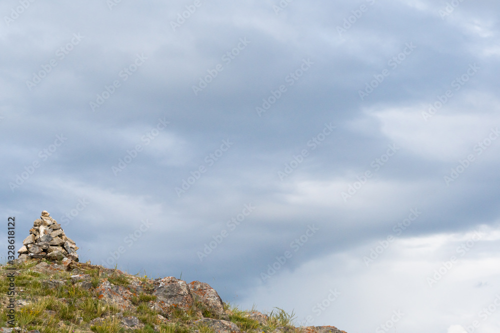 Slide of stones for orientation in forest. Hiking in mountains. Meditation, state of balance of  soul. Yoga classes in nature