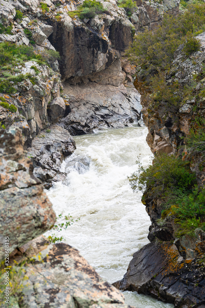 rapid river in mountain gorge, bubbling stream among the rocks, test for rafting rapid river in mountain gorge, bubbling stream among the rocks, test for rafting