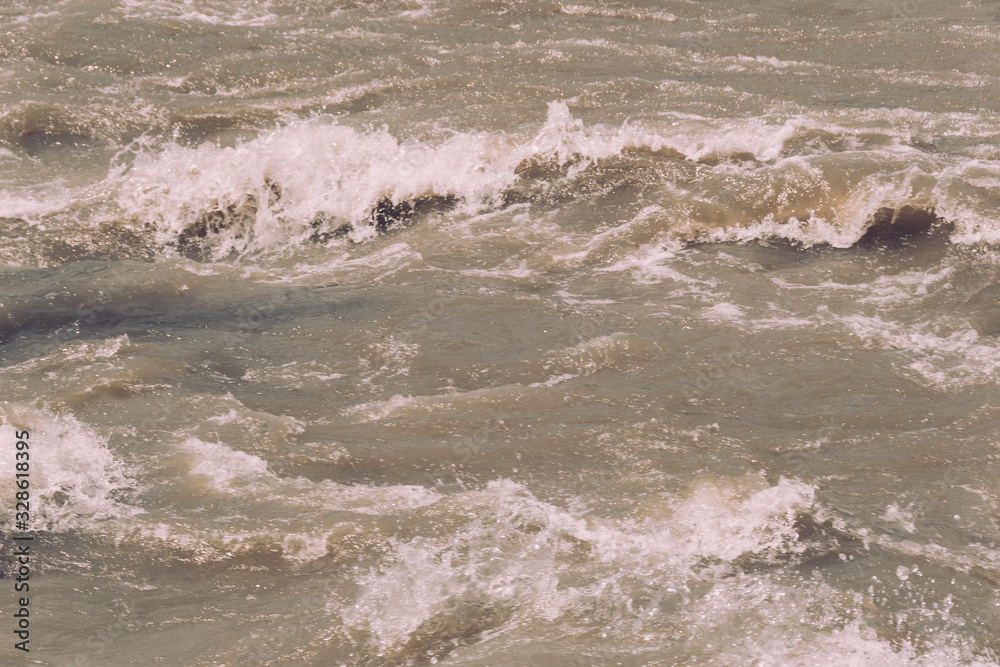 Obraz premium rushing water of fast flowing river, storm waves of ocean, sea surf