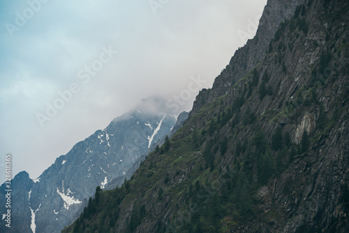 silhouette of mountain range on horizon, rocks and cliffs in mountain valley, tourist trip to mountains