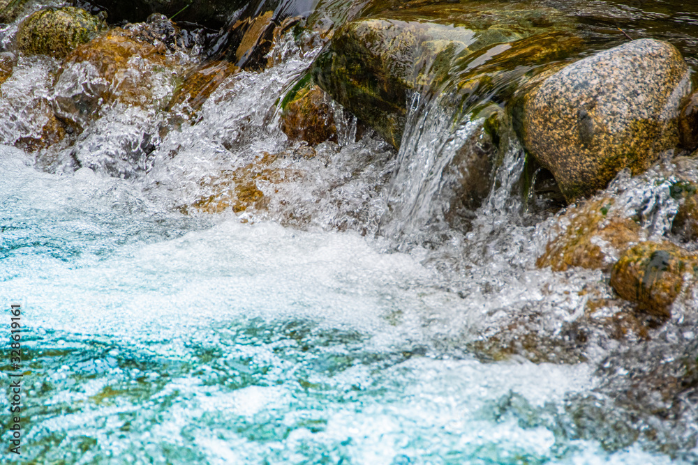 fast flowing river. Mountain stream among rocks. Water tourist trip fast flowing river. Mountain stream among rocks. Water tourist trip