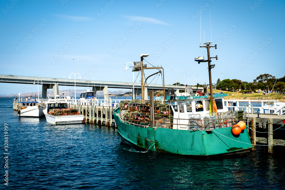 Fishing yachts parked at dock with a bridge connecting Phillip Island with San Remo area Fishing yachts parked at dock with a bridge connecting Phillip Island with San Remo area
