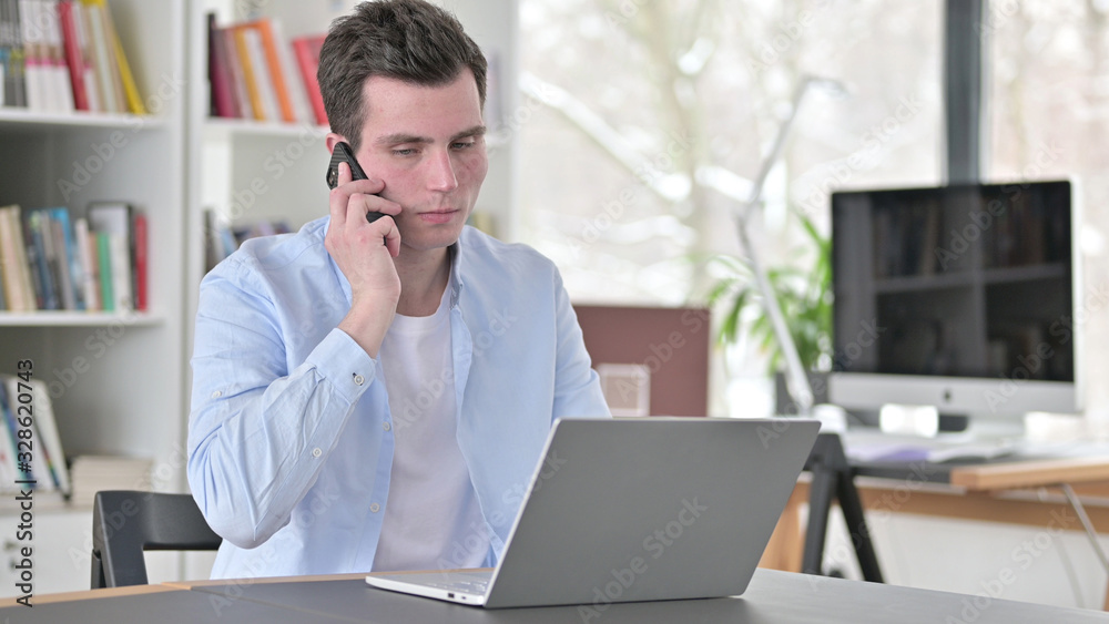 Upset Young Man Arguing on Smartphone Upset Young Man Arguing on Smartphone